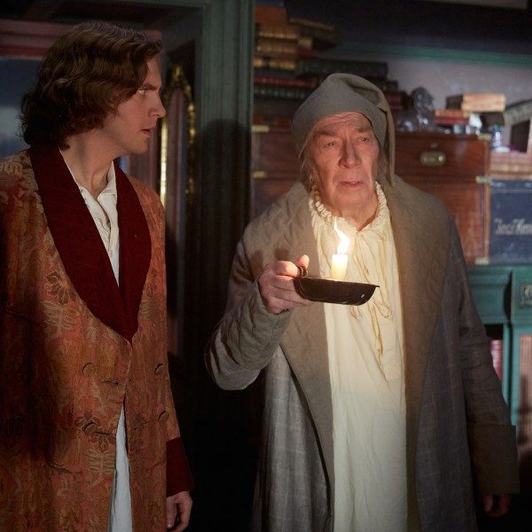 Dan Stevens (left) stars as Charles Dickens and Christopher Plummer (right) stars as Ebenezer Scrooge.